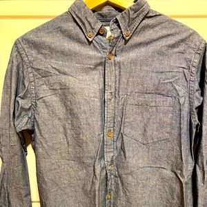 Collared navy blue jean shirt.